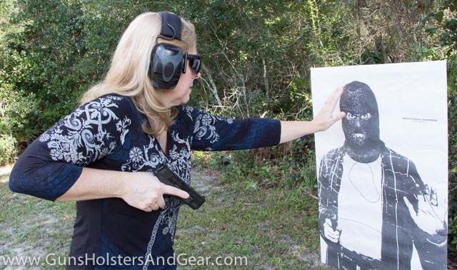 Cute Blonde Training with Pistol