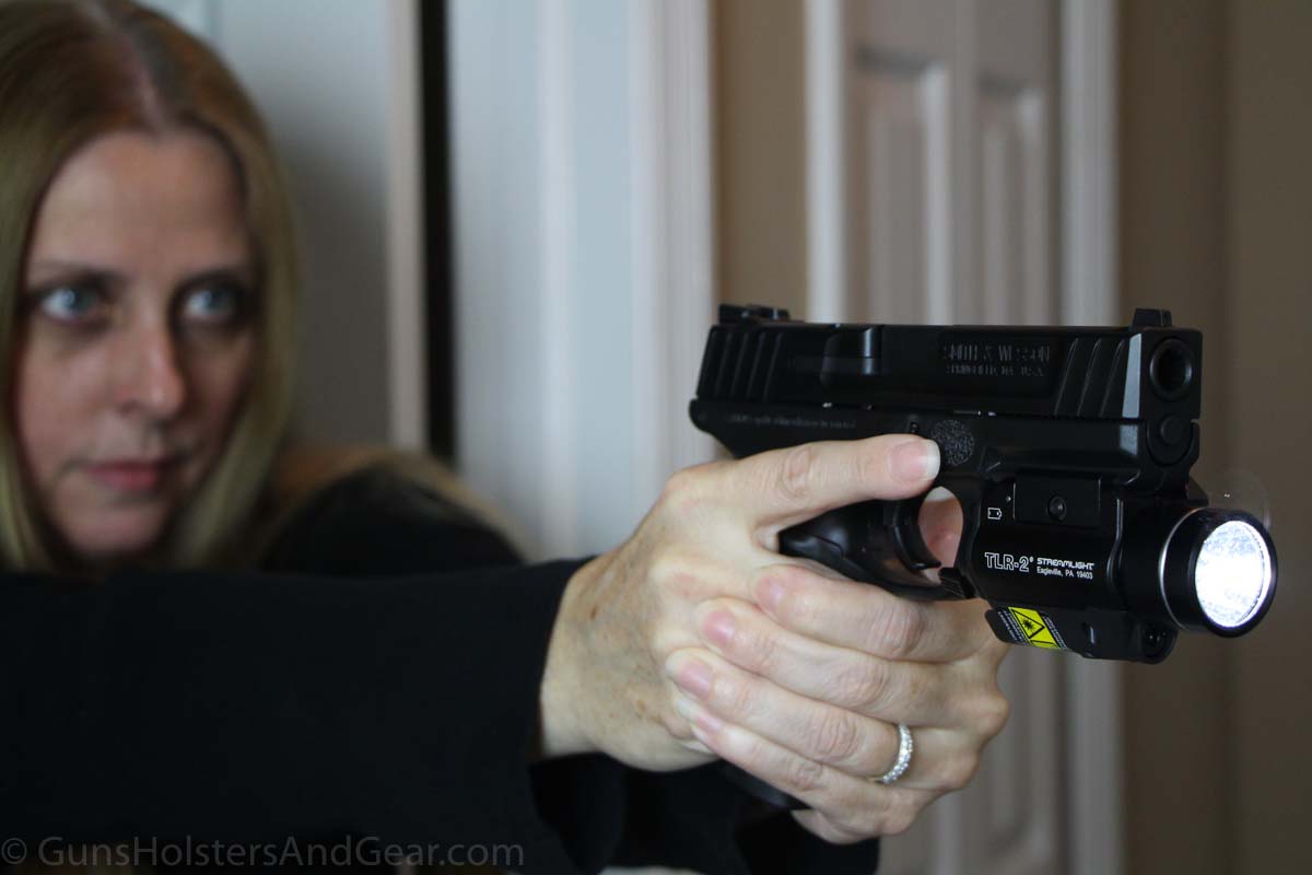 Beautiful Woman Shooting Smith & Wesson SD40 with Weapon Light